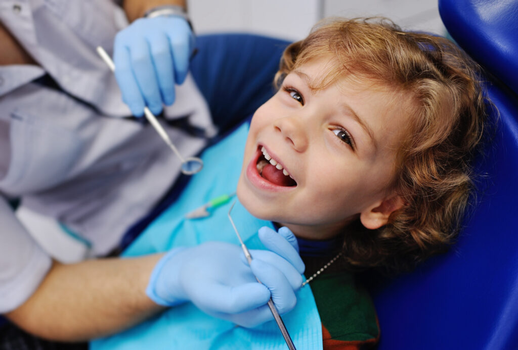 Pediatric dentist performing a root canal for kids, also called a pulpotomy, in Orlando