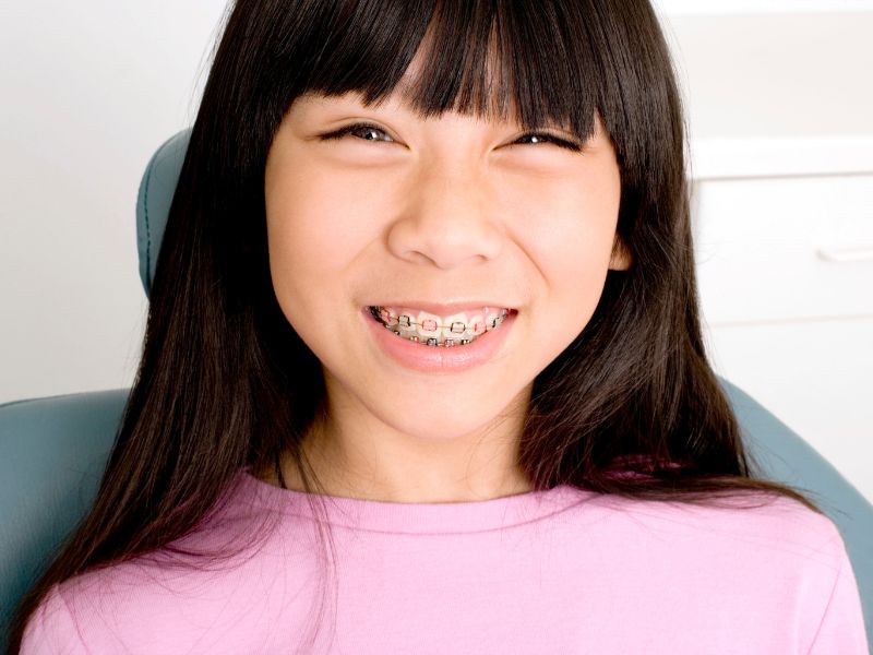 Child smiling with new braces for kids at our office near Kissimmee