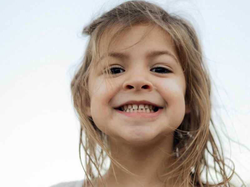 Young child with a mix of baby and adult teeth, the right age for an early orthodontic treatment check near Kissimmee