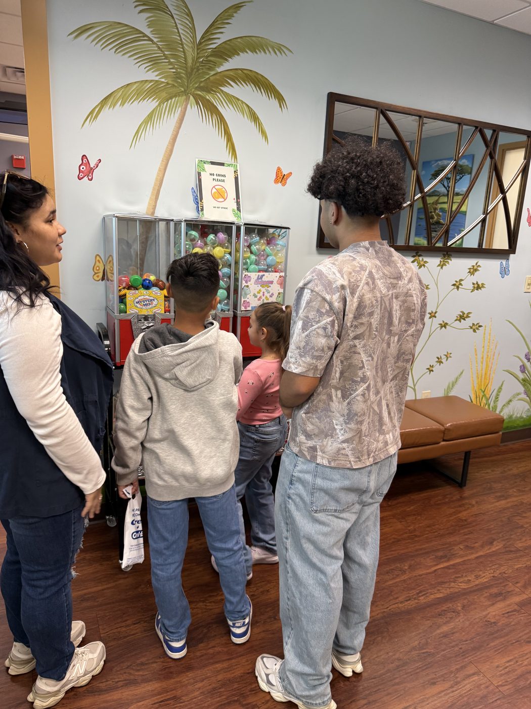 A family picking prizes together in the pediatric dental office waiting area