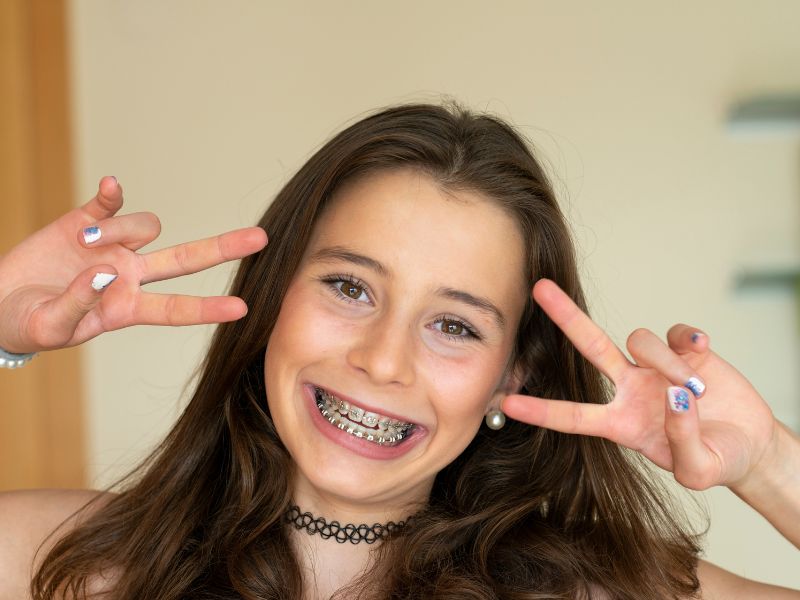 Orthodontics for children, teens and adults in Kissimmee: a smiling girl showing her new braces